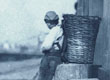 The young ragpicker leaning on a bollard